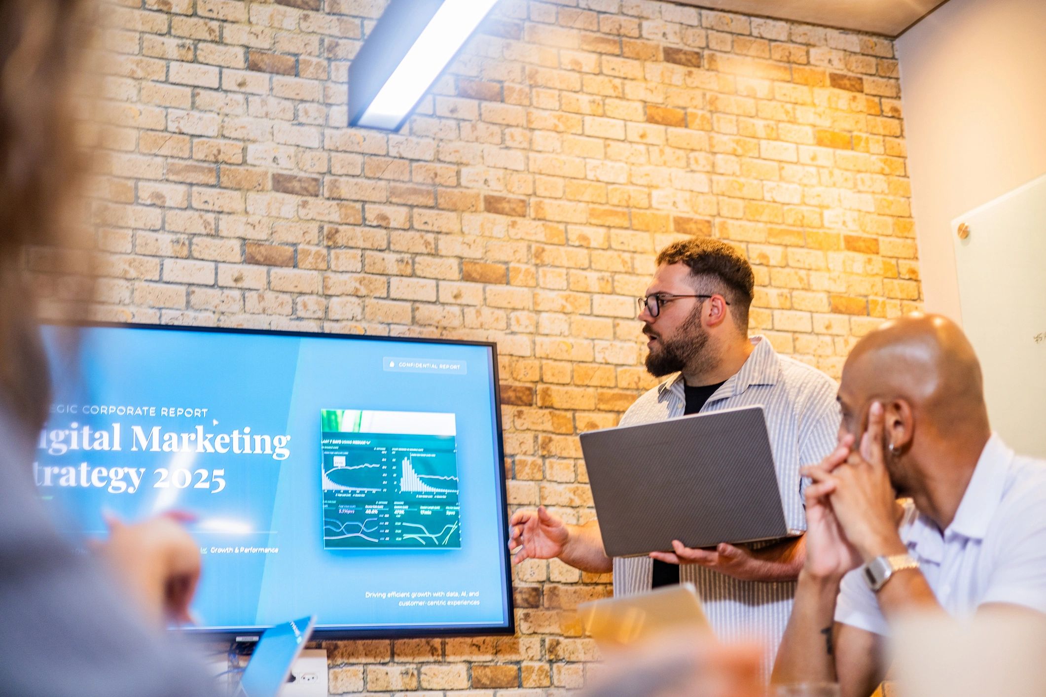 Presenter discussing strategy with colleagues